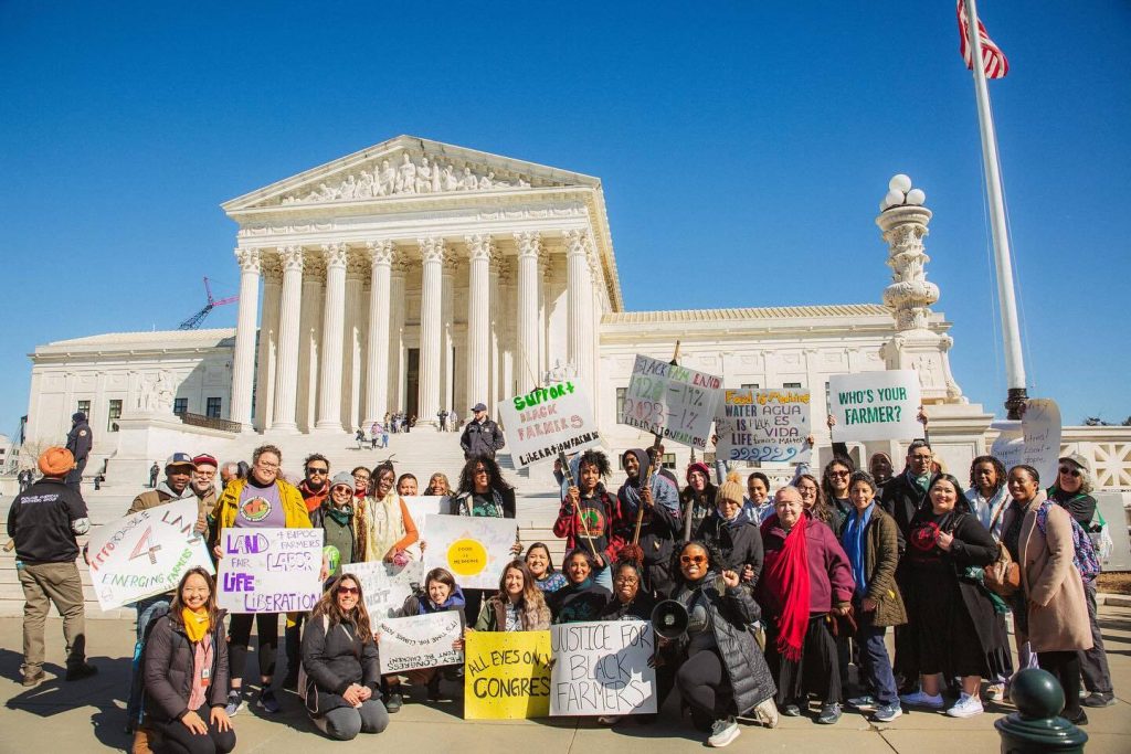 A group of HEAL Food Aliance activits posed in front of a government building in Washington DC